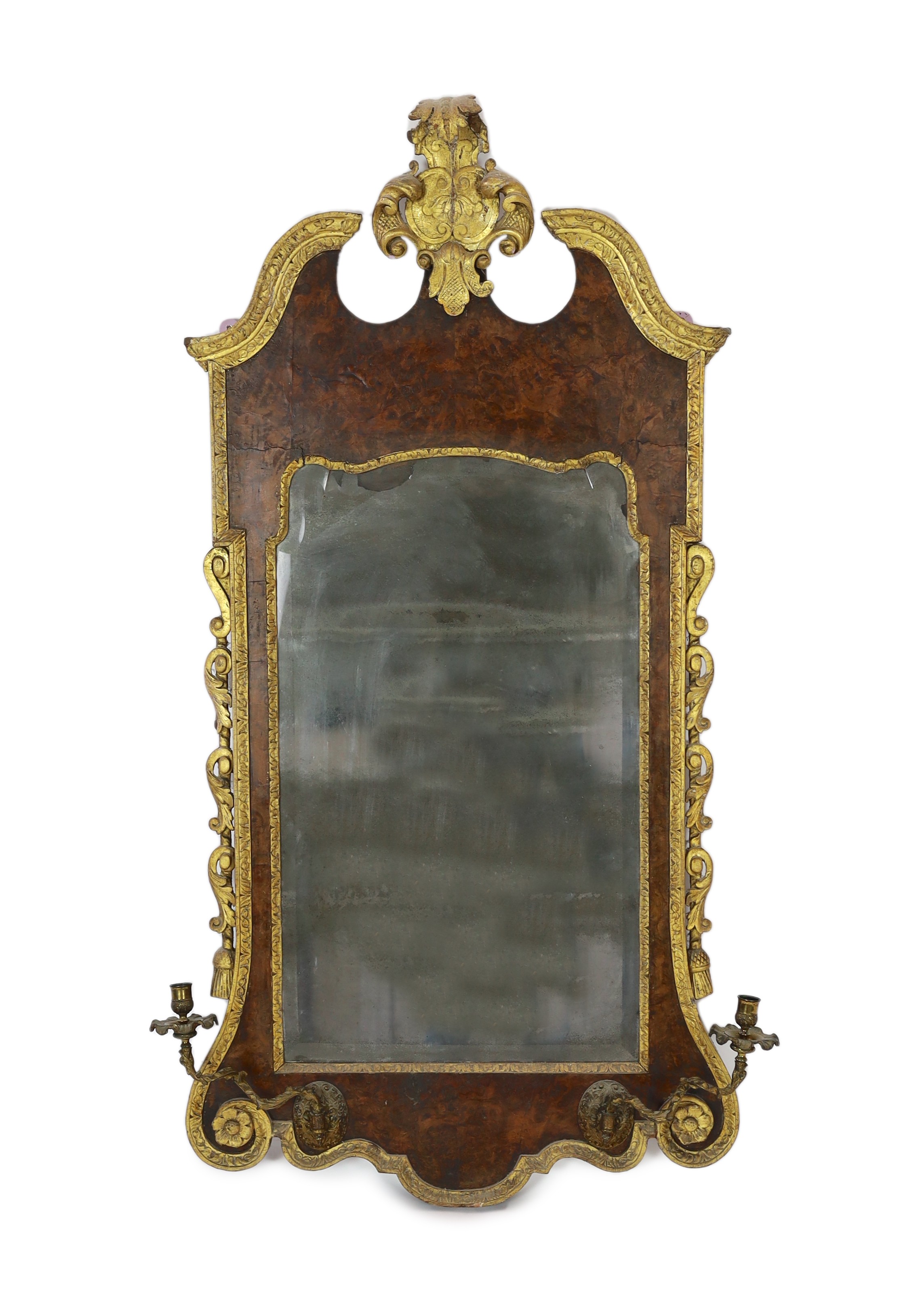 A George II and later carved giltwood and burr walnut wall mirror, 133.5cm high, 69cm wide